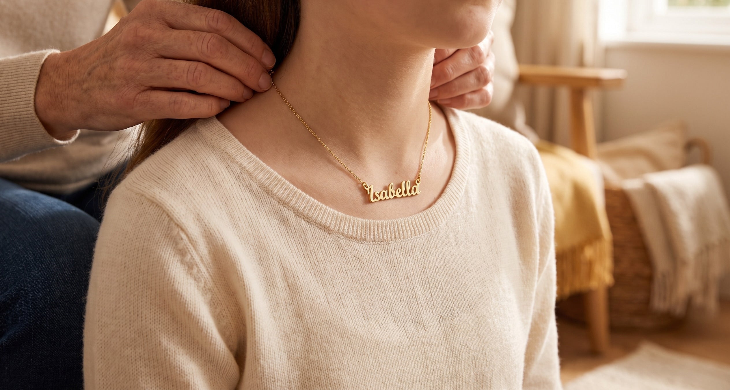Mum fastening a personalised name necklace on her teenage daughter at home