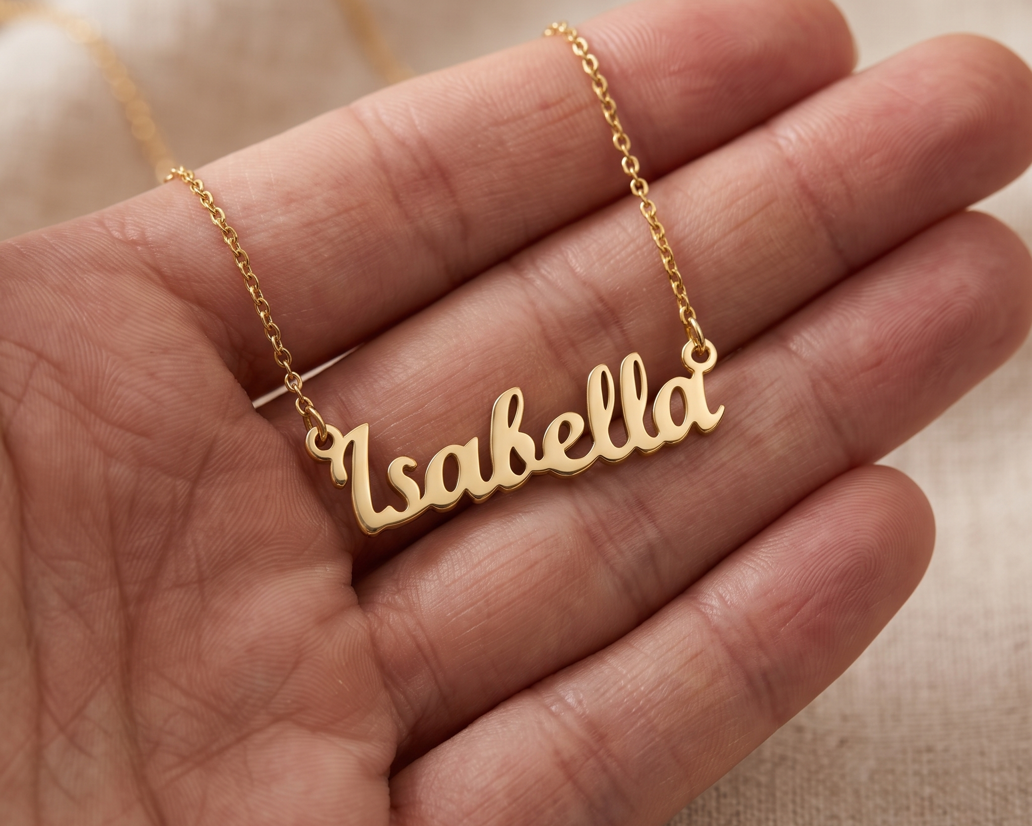 Layered necklaces and a stacked hand shown together in everyday light