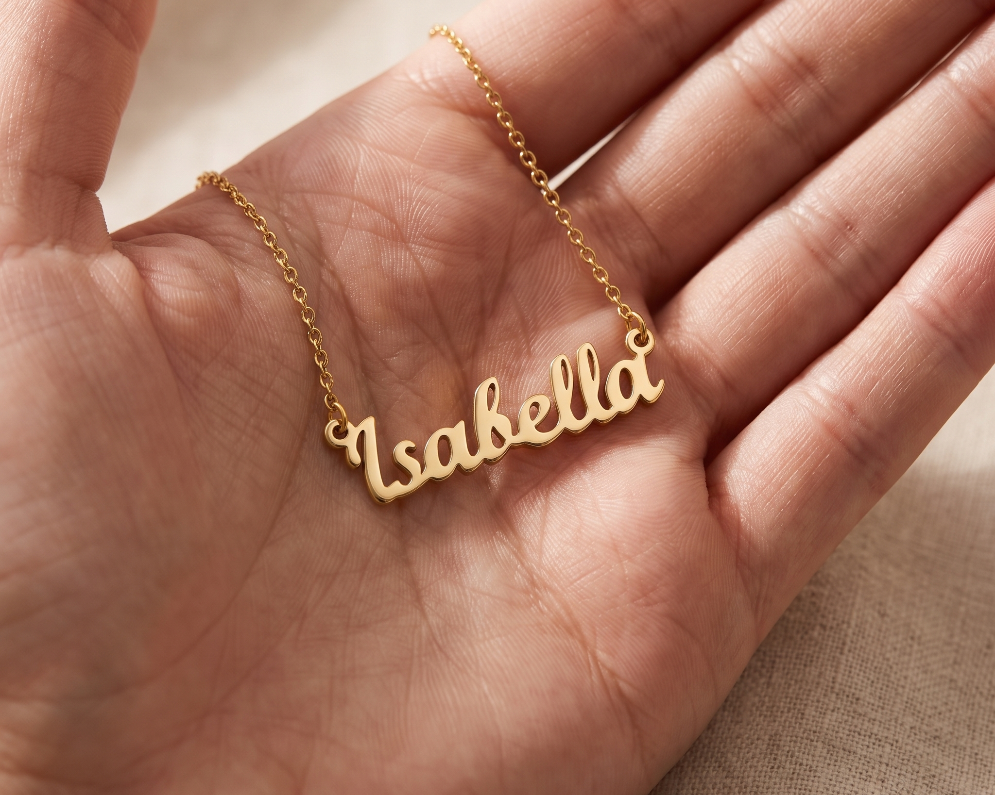 Engraved personalised pendant resting in an open palm