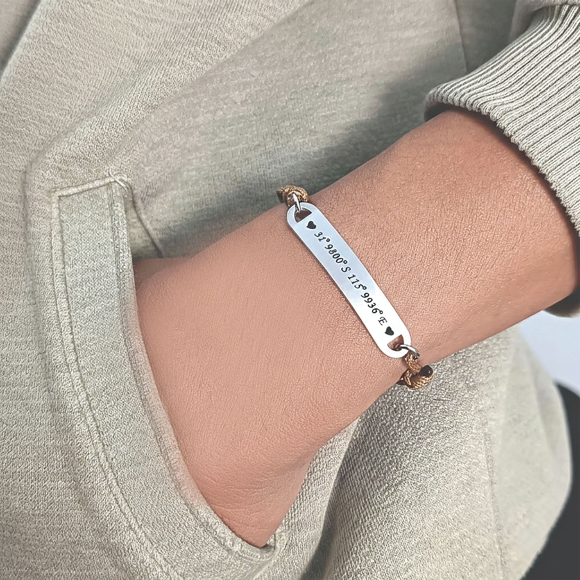 Belle Fever bar cord bracelet styled on wrist, custom engraved name or coordinates bracelet, adjustable unisex keepsake jewelry.