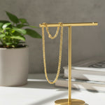 Premium gold curb chain necklace on display stand, waterproof unisex jewelry designed for lasting shine and durability.