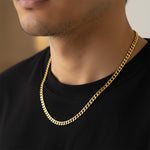 Gold curb chain necklace worn by man, waterproof non-tarnish unisex chain with bold timeless appeal.