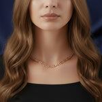 Close-up gold curb chain necklace on woman, waterproof non-tarnish unisex jewelry with sleek modern finish.