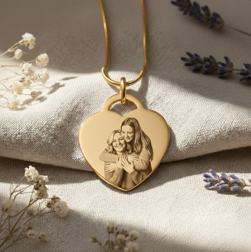 Forever in My Heart Photo Necklace by Belle Fever — gold heart pendant with personalised photo engraving, styled on fabric with gentle florals, a timeless keepsake honouring deep connection.