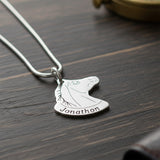 Belle Fever Horse Head Necklace with Custom Name in bright silver finish on dark wood surface, custom engraved horse pendant necklace, personalised equestrian jewellery gift.