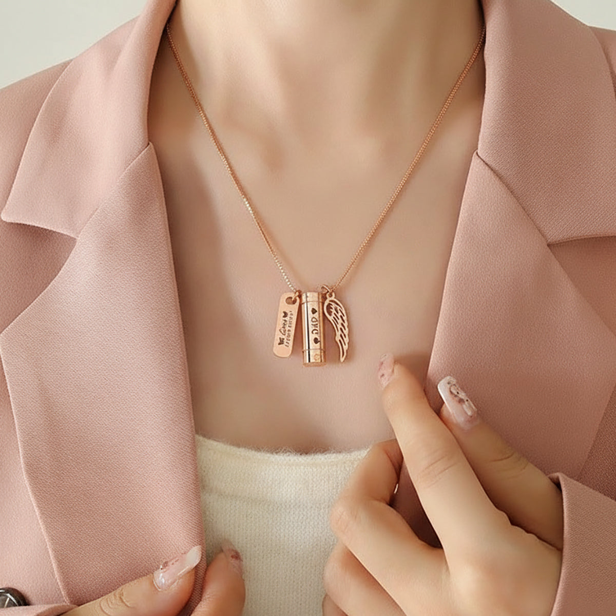 Belle Fever Memory Cremation Necklace worn close to the heart — rose gold pendant with engraved charm and angel wing, keeping loved ones’ memory alive.