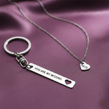 Belle Fever missing piece jewellery set styled on soft purple fabric, couple anniversary gift, romantic everyday necklace and keychain keepsake