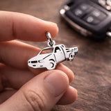 Belle Fever silver pick up charm held in fingers, meaningful driver gift keyring, safe drive reminder for him.