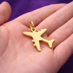 Belle Fever gold plane charm for keyring in palm, shiny travel airplane charm with smooth polished finish.