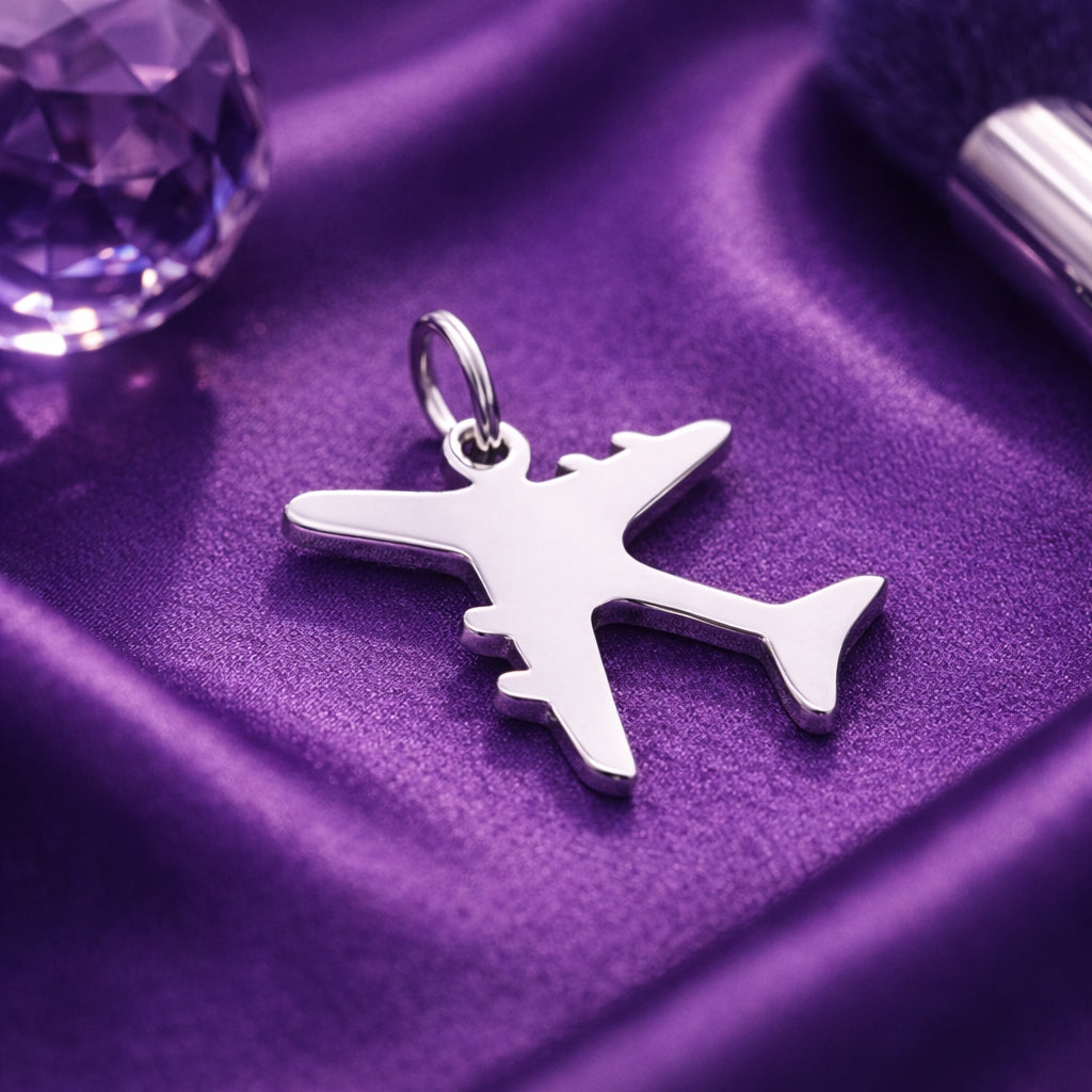 Belle Fever silver plane charm for keyring on purple satin, minimalist travel airplane charm.