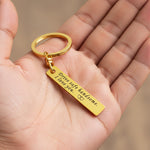 Belle Fever engraved reminder tag keychain held in hand, gold bar keepsake with personal message, sentimental gift for loved one