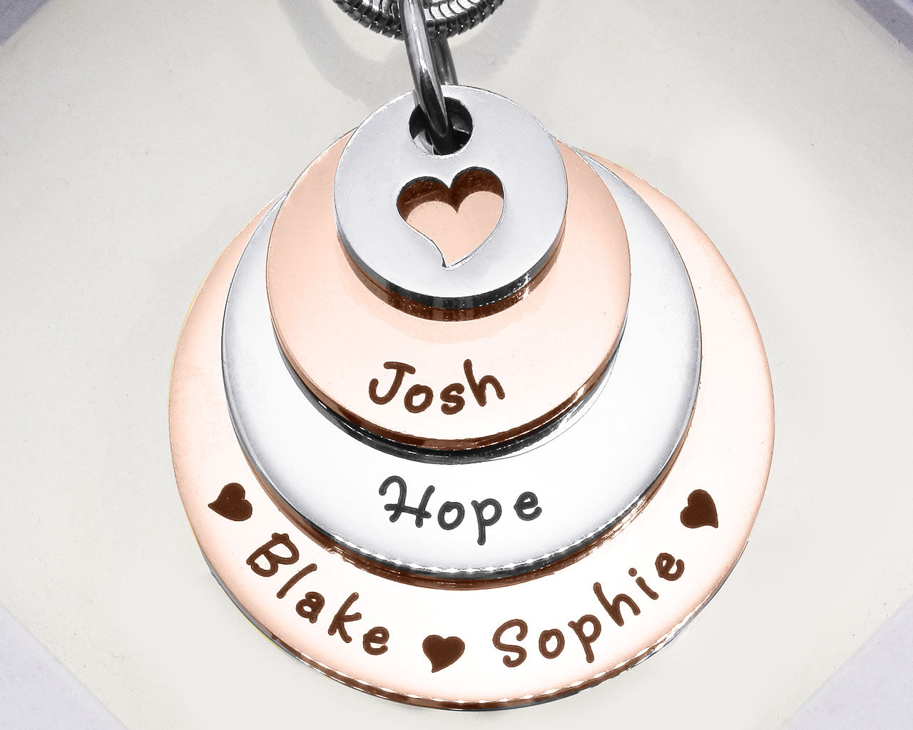 Two tone rose gold Tower of Love necklace displayed on a white background, layered charm pendant detail by Belle Fever