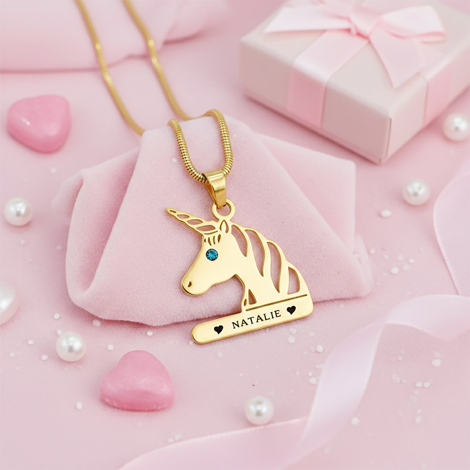 Gold unicorn head necklace featuring birthstone detail and custom engraved name pendant.