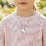 Unicorn head necklace with birthstone and engraved name worn by young girl.