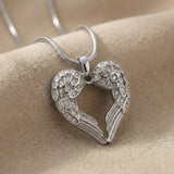 Angels Heart necklace in silver featuring heart shaped angel wings pendant with stone accents