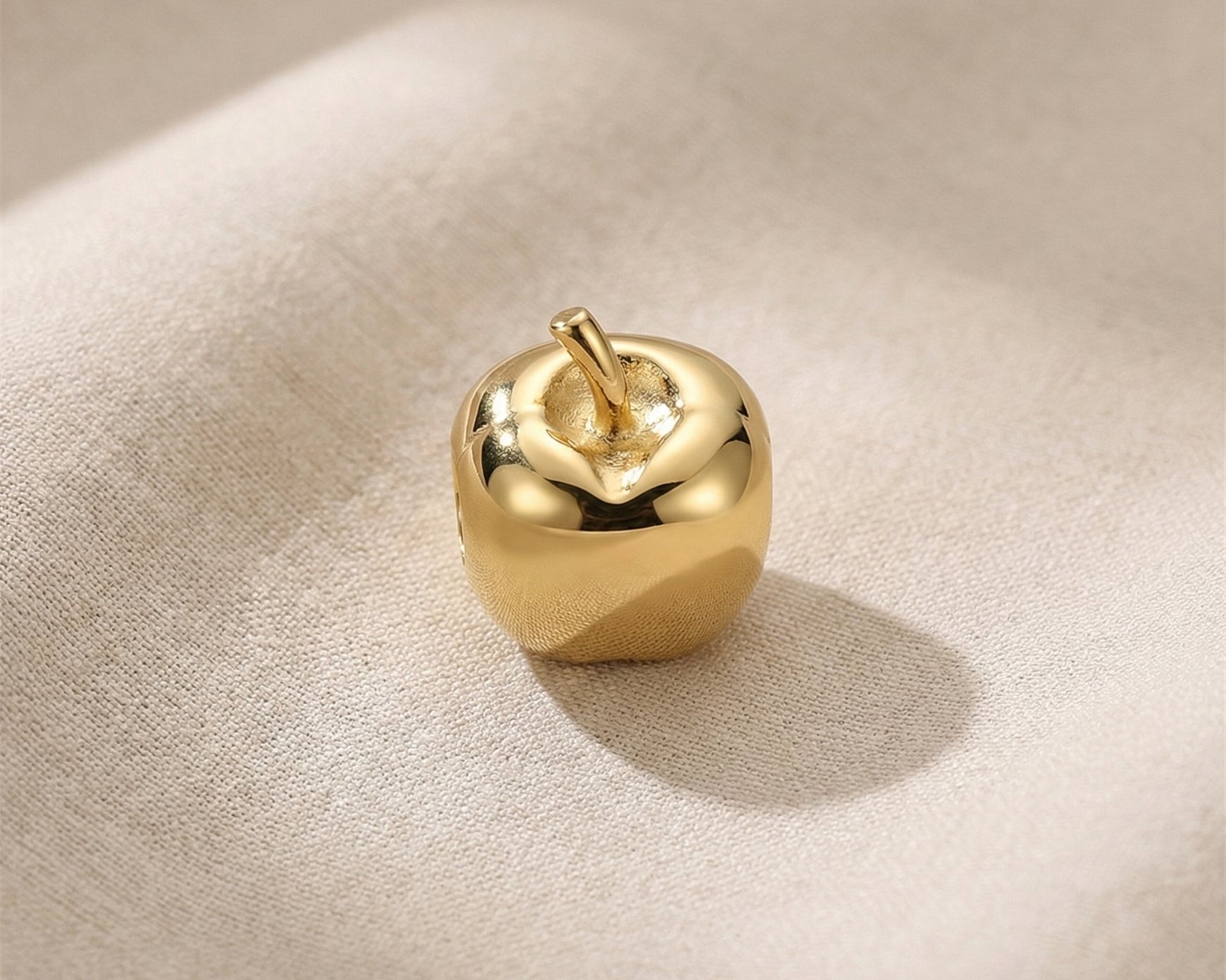 Gold apple charm for Moments Bracelet with polished finish and minimalist luxury jewelry design