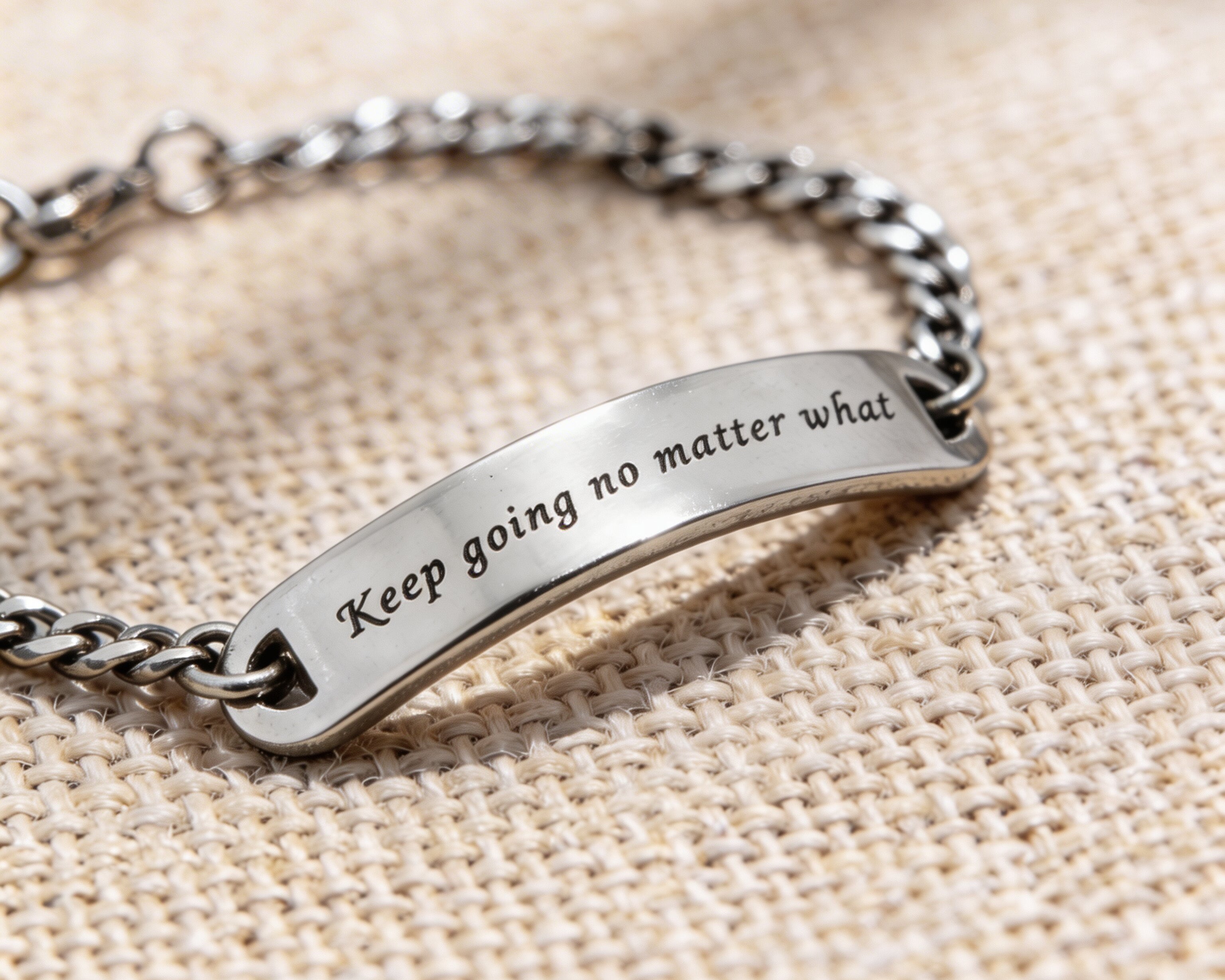 Silver bar bracelet featuring engraved plate detail
