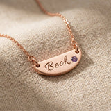 Rose gold Beck name necklace with engraved bar pendant and birthstone detail