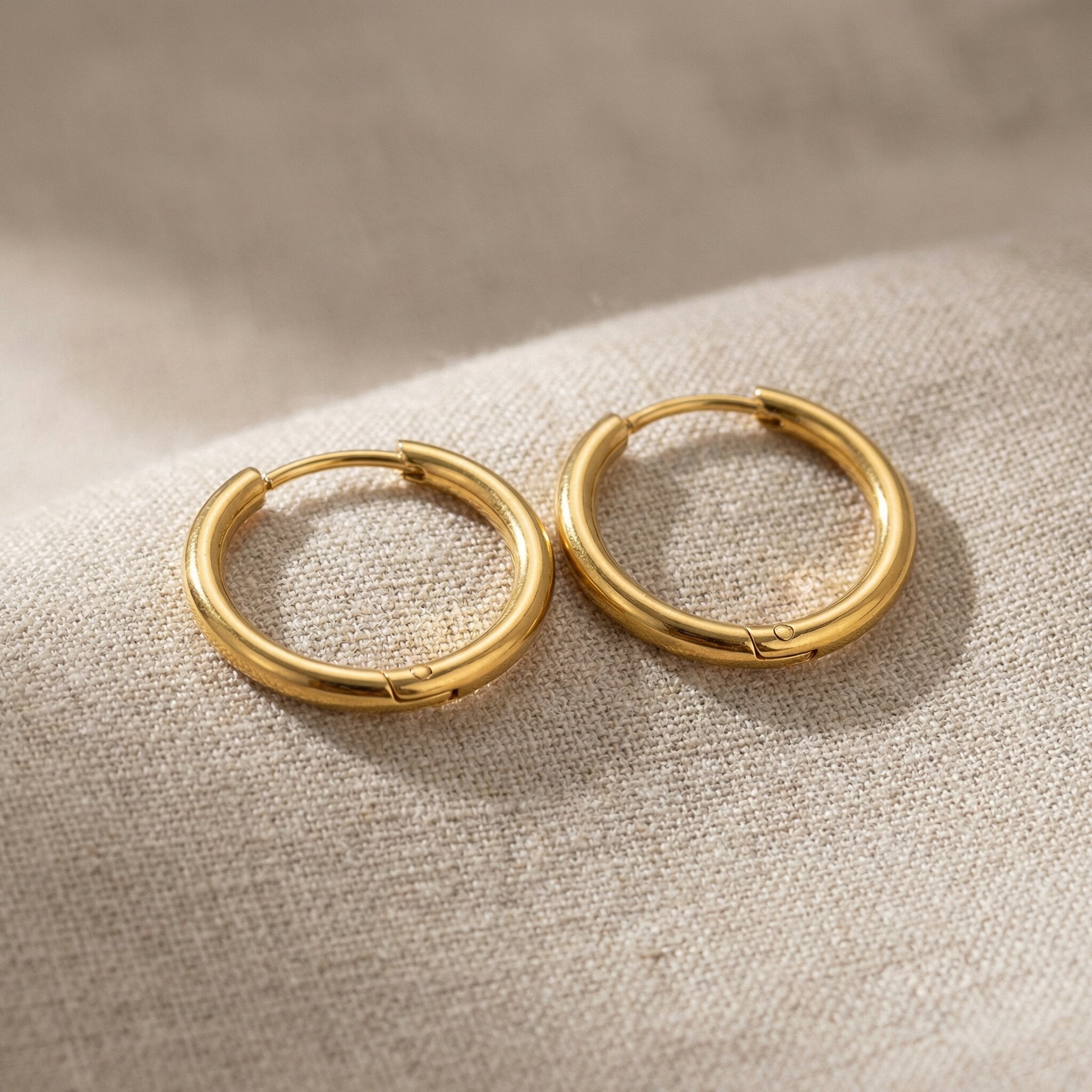 Gold chic sleeper hoop earrings with classic round hoop design displayed on neutral background