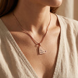 Woman wearing children heart birthstone necklace, meaningful family jewellery celebrating love and children connection
