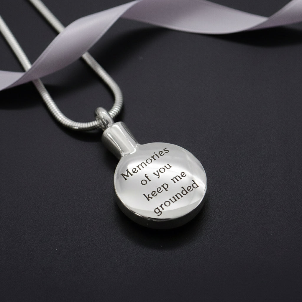 Belle Fever silver Circle Cremation Necklace, round engraved memorial pendant for ashes, personalised remembrance jewellery keepsake, modern sympathy gift styled on dark background.