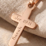 Close up of cross name necklace showing engraved name detail on cross pendant