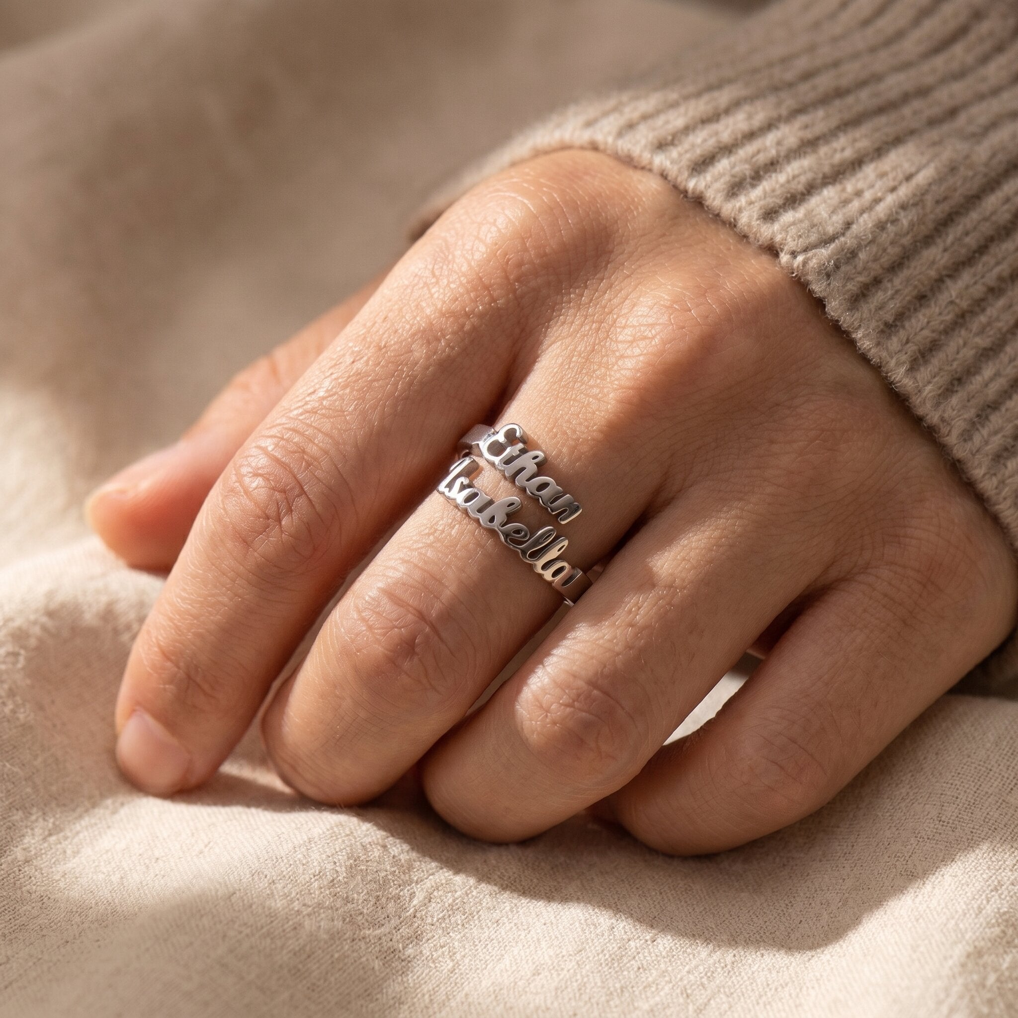 Woman wearing personalized double name ring with elegant custom lettering and minimalist jewelry styling
