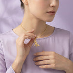 Belle Fever Dragonfly Necklace with Custom Engraved Names held gently near collarbone, gold transformation jewellery gift symbol of resilience and growth.