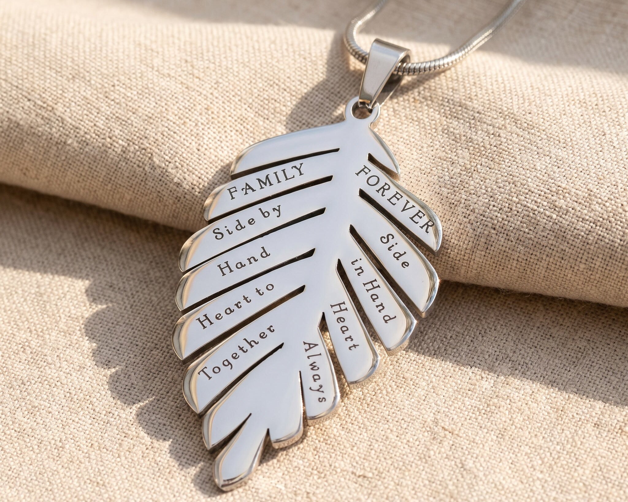 Family leaf necklace in silver with engraved detail, symbolic family jewellery keepsake