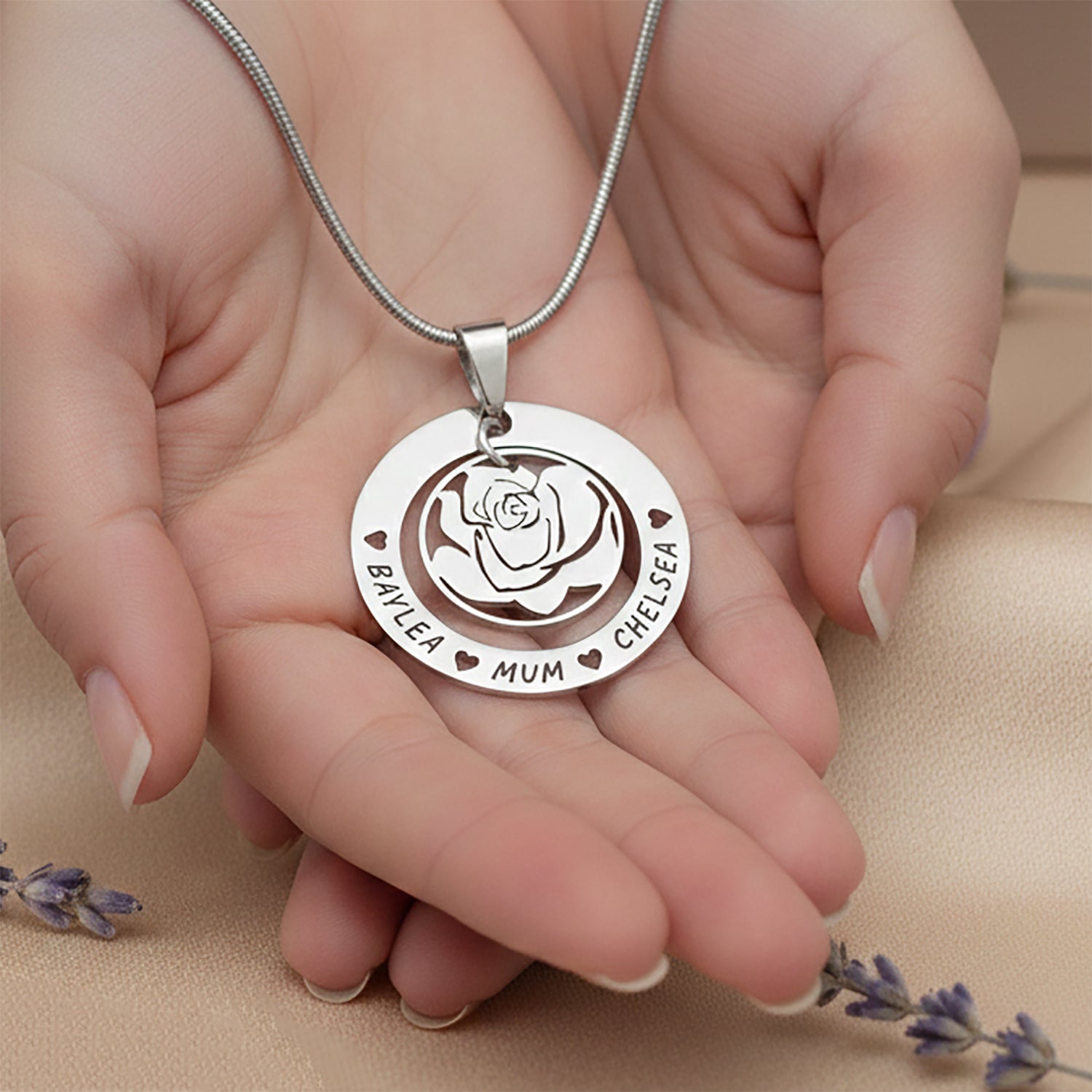 Personalizedrose family necklace with engraved family names held in hand, belle fever custom family pendant gift.