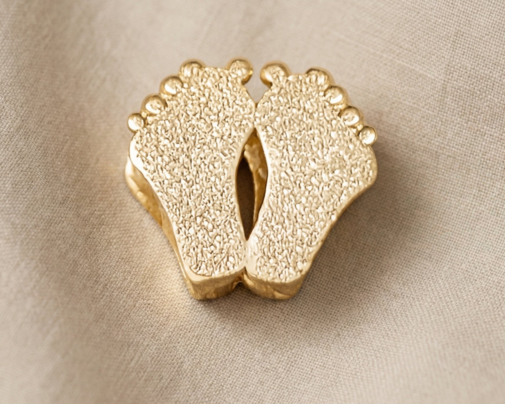 Gold baby feet charm for Moments Bracelet symbolizing motherhood, newborn memories, and family love