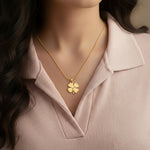 Belle Fever Personalized Four Leaf Clover Necklace – a woman gently wearing a gold clover pendant close to her heart, symbolizing love, good luck & new beginnings