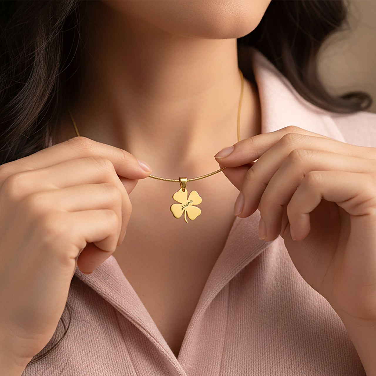 Belle Fever Personalized Four Leaf Clover Necklace – a woman gently wearing a gold clover pendant close to her heart, symbolizing love, good luck & new beginnings