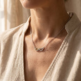 Woman wearing highs and lows necklace, symbolic jewellery representing life journey and connection