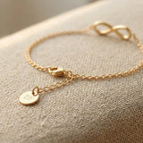 Close up of infinity bracelet with delicate chain and infinity symbol detai