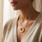 Woman wearing Interlinked Love Ring Necklace with interlocking rings, personalised jewellery lifestyle image