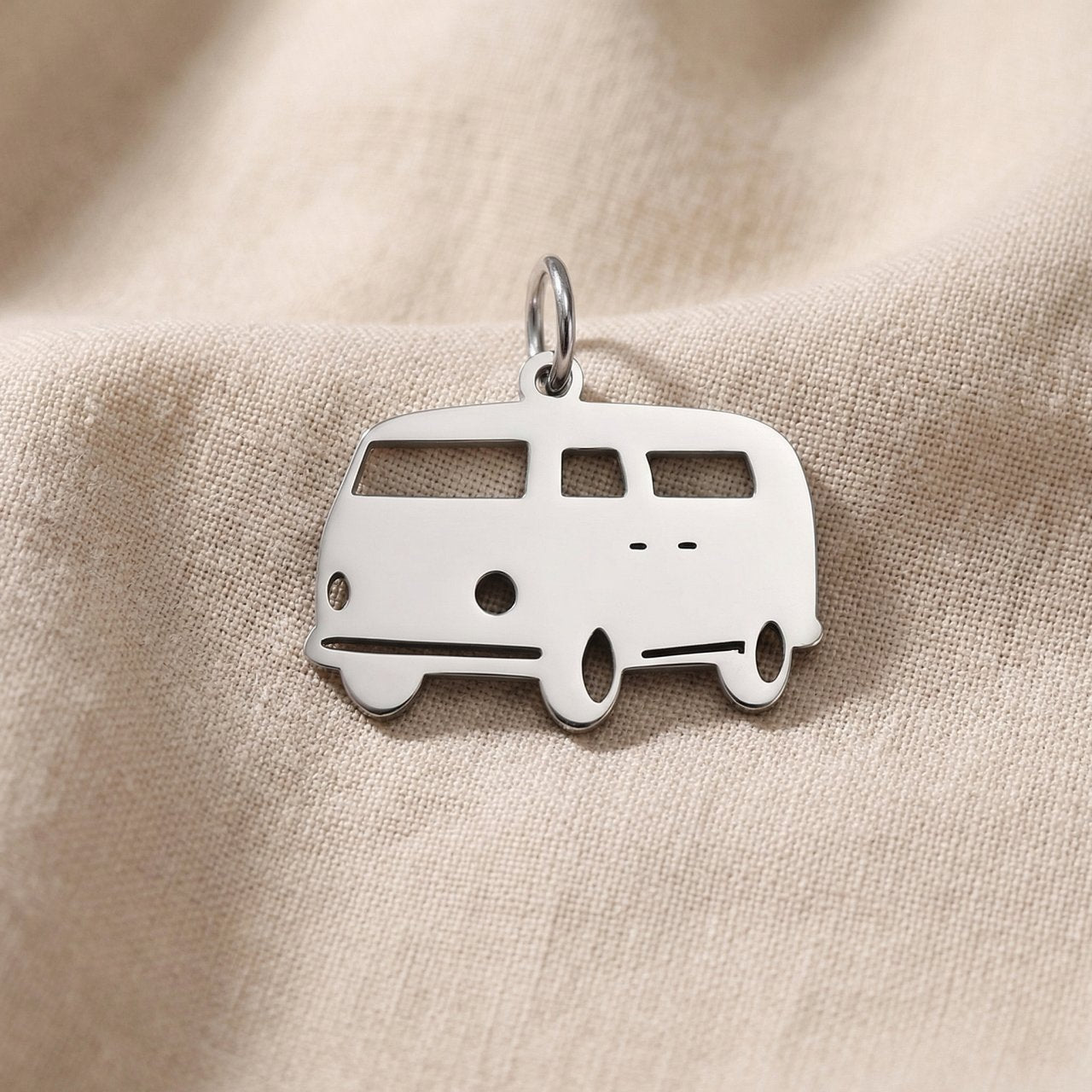 Silver kombi van charm for keyring symbolizing travel adventures, freedom, and road trip memories