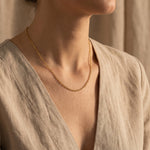 Woman wearing link chain necklace, minimalist chain jewellery for layering and modern everyday styling