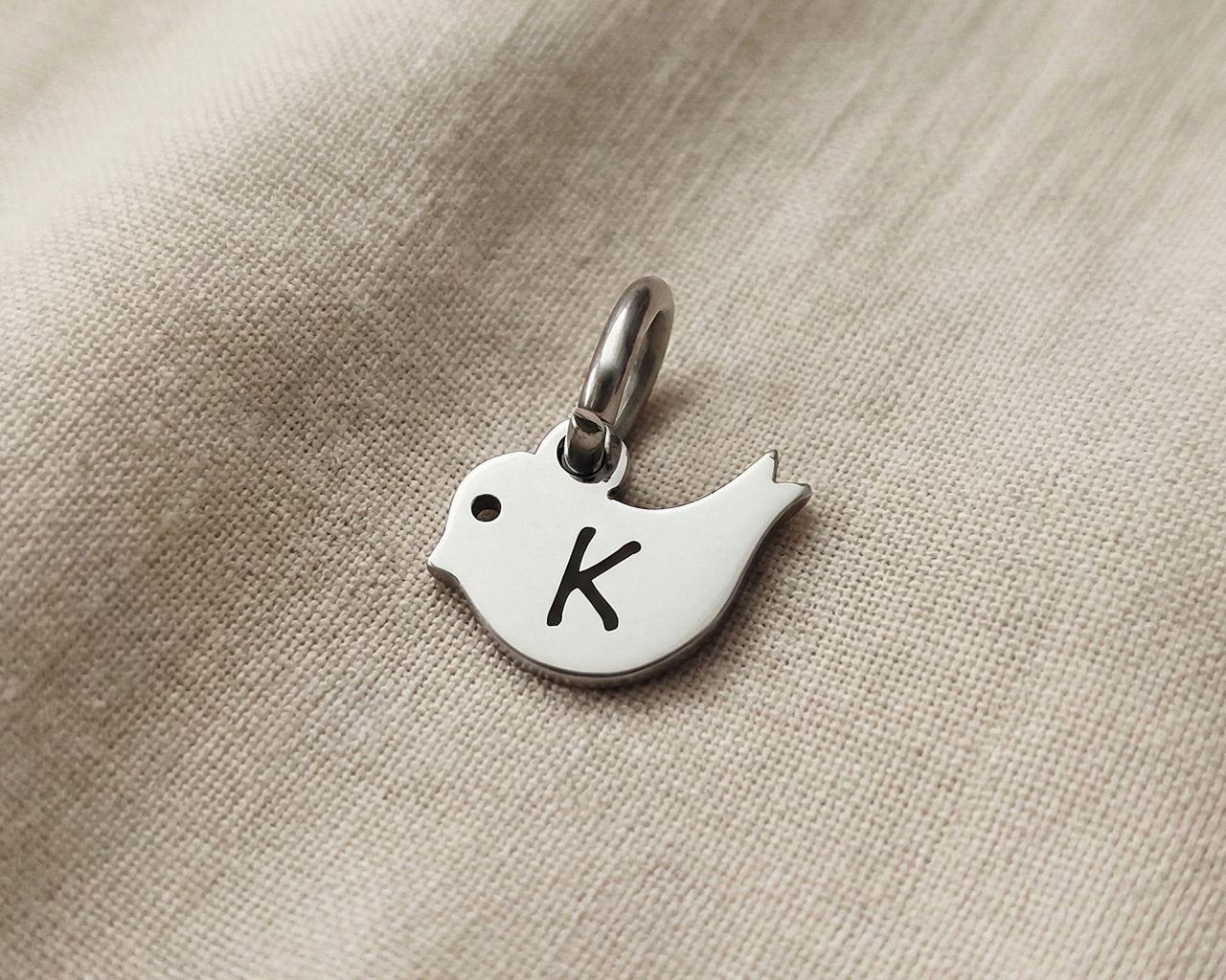 Personalized little bird charm for keyring with engraved initial symbolizing freedom, hope, and remembrance