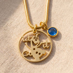 Melting snowman birthstone necklace in gold with unique design and blue birthstone charm