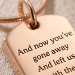 Close-up of memory tag cremation necklace with engraved memorial message and ashes keepsake detail