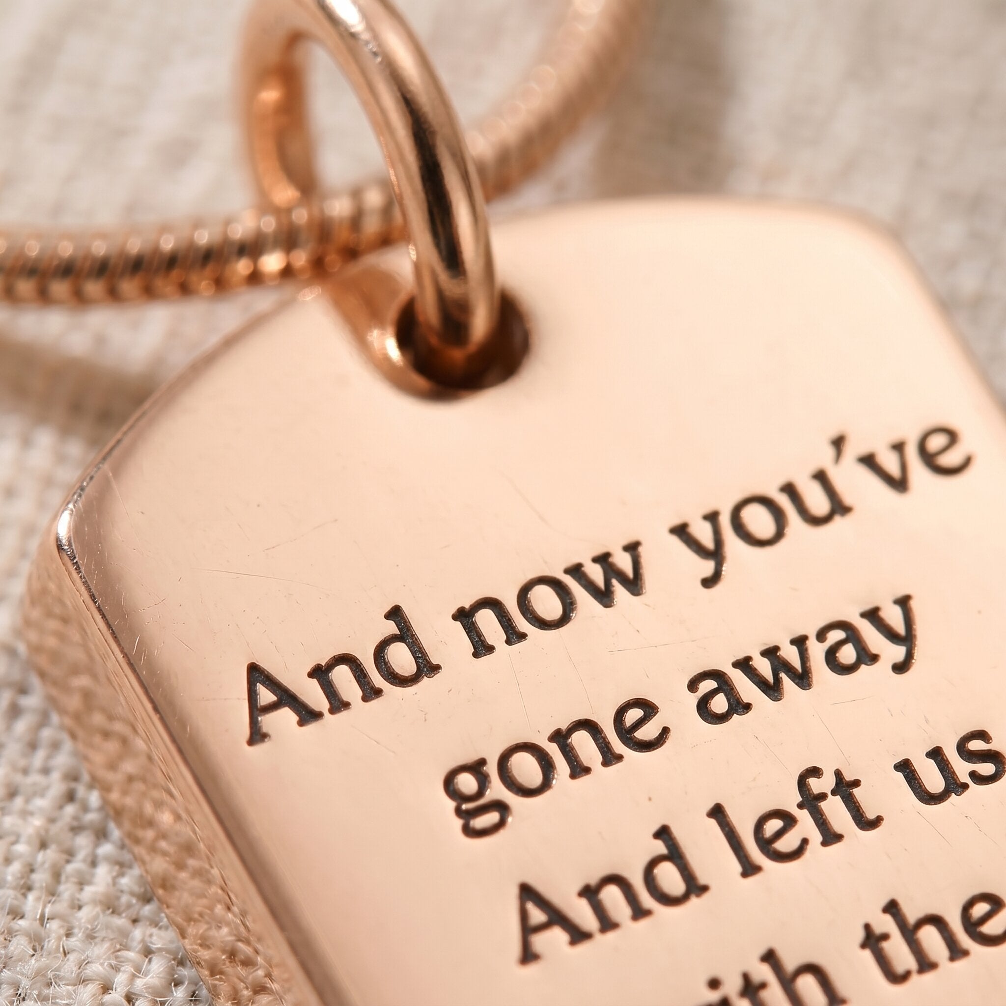 Close-up of memory tag cremation necklace with engraved memorial message and ashes keepsake detail