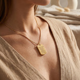 Woman wearing memory tag cremation necklace, meaningful memorial jewellery for ashes and remembrance keepsake