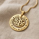 Gold My Family Tree necklace with circular tree of life pendant displayed on neutral background