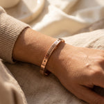 Woman wearing open cuff bangle, minimalist personalised jewellery for everyday style and meaningful gifting