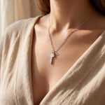 Woman wearing open doors necklace, elegant jewellery symbolising faith, guidance and new beginnings