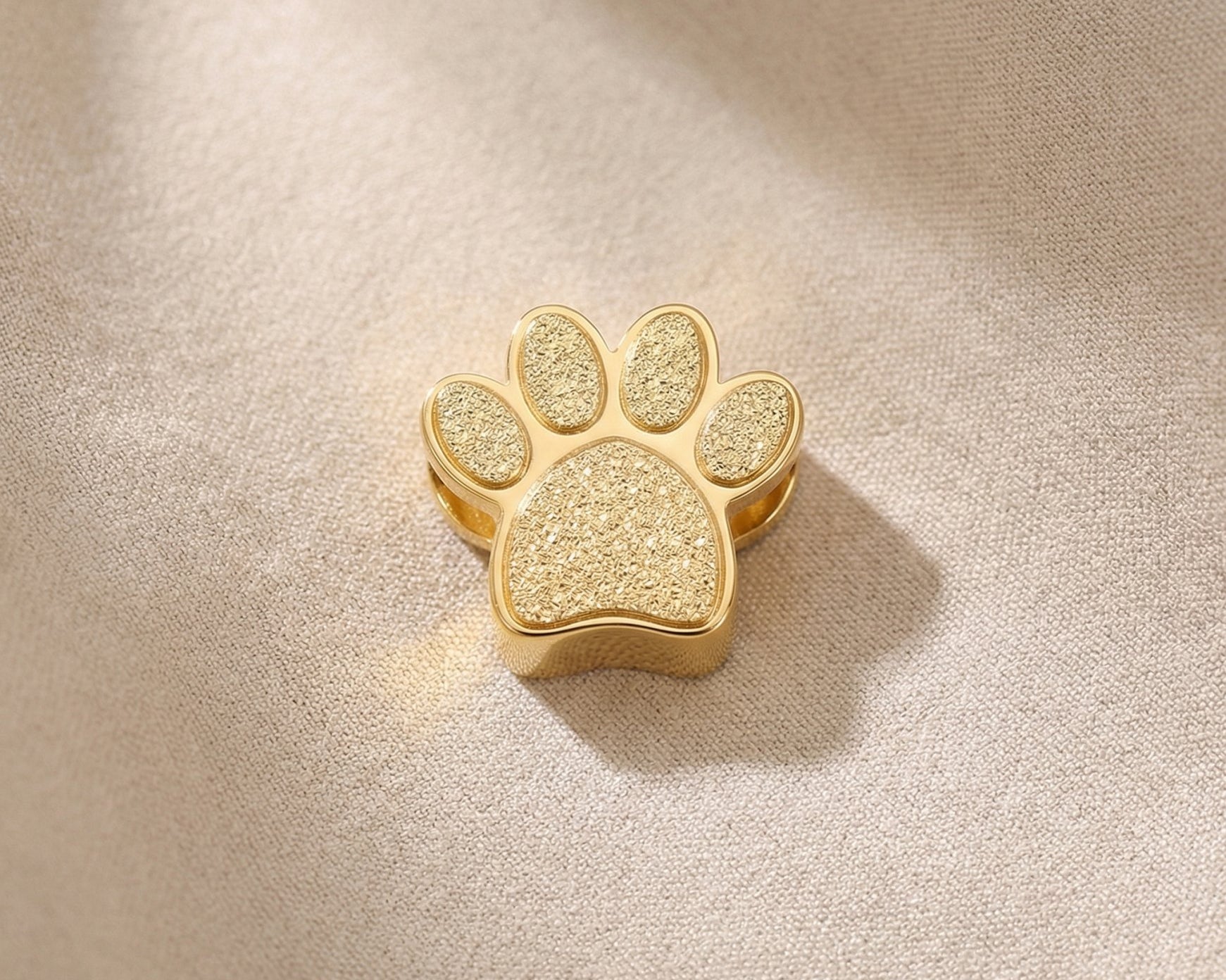 Gold paw print charm for Moments Bracelet celebrating pet lovers and meaningful animal companionship