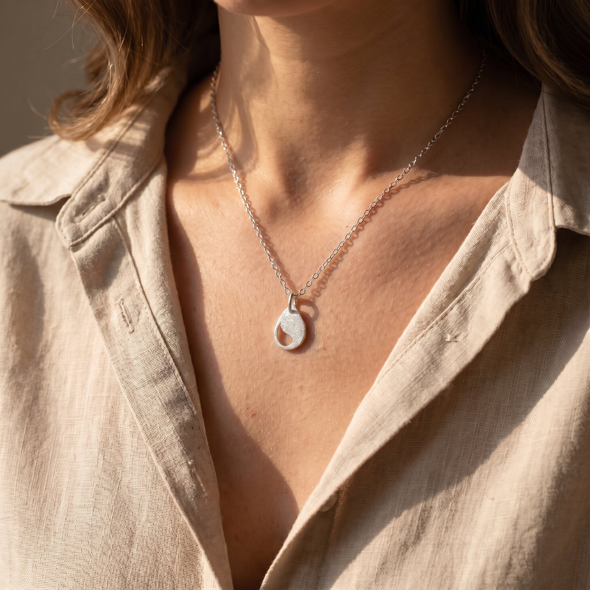 Woman wearing persistence necklace, elegant jewellery representing resilience and inner strength