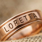 Close-up of personalised band ring with engraved name detail showing fine craftsmanship and finish