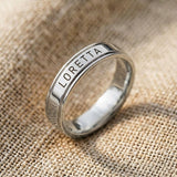 Silver personalised band ring with engraved name detail, minimalist custom jewelry close-up